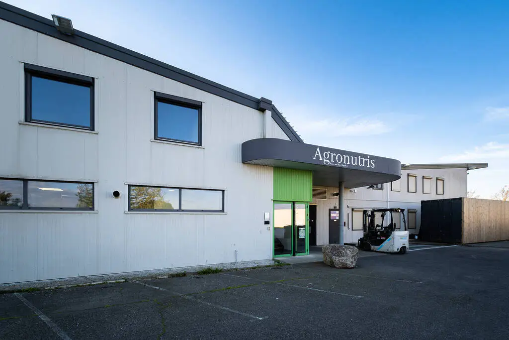 Industrial building with "Agronutris" sign and forklift.