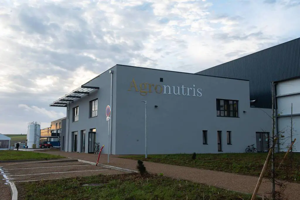 Agronutris building exterior with cloudy sky.