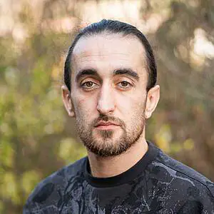 Man with beard in natural background.