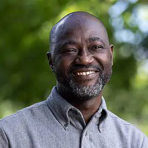 Smiling man with beard outdoor.