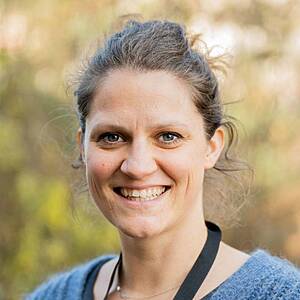 Woman smiling in natural daylight.
