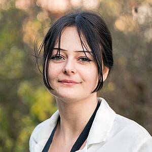Woman smiling outdoors.