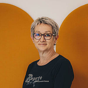 Woman smiling against orange background