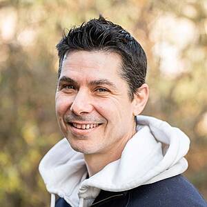 Smiling man outdoors in casual wear.