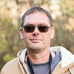 Man with sunglasses outdoors.
