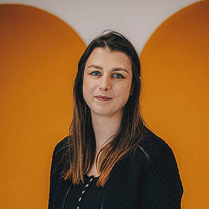 Woman smiling in office environment.