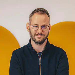 Man in glasses with a slight smile.